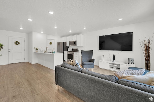 8622 W Cordero Dr S Unit 1170, Magna, UT 84044 - living room with recessed lighting, light wood-style floors, and baseboards