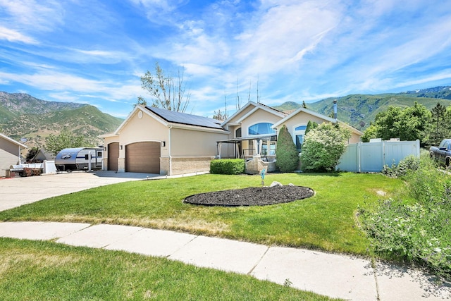 7776 S 2175 E, South Weber, UT 84405 - ranch-style house featuring stucco siding, a mountain view, driveway, roof mounted solar panels, and an attached garage