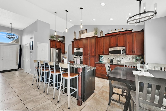 7776 S 2175 E, South Weber, UT 84405 - kitchen featuring stainless steel appliances, a chandelier, backsplash, a kitchen island with sink, and light tile patterned floors