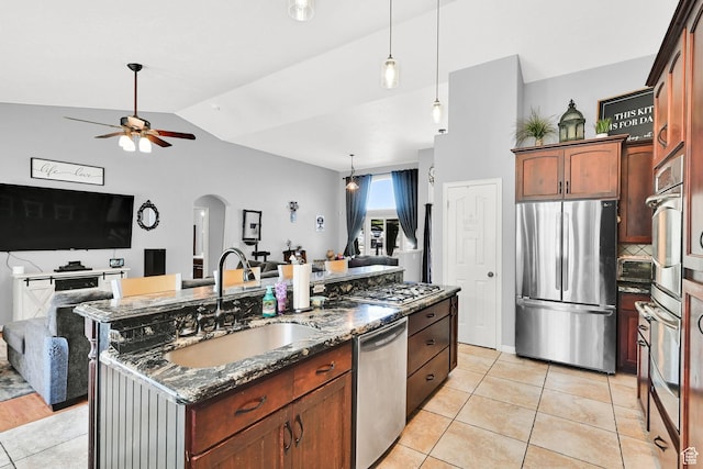 7776 S 2175 E, South Weber, UT 84405 - kitchen with stainless steel appliances, a sink, open floor plan, ceiling fan, and arched walkways