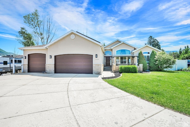 7776 S 2175 E, South Weber, UT 84405 - single story home with concrete driveway, a garage, a front lawn, and stucco siding