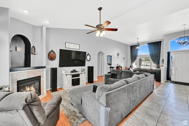 7776 S 2175 E, South Weber, UT 84405 - living area with arched walkways, a fireplace, vaulted ceiling, ceiling fan, and baseboards