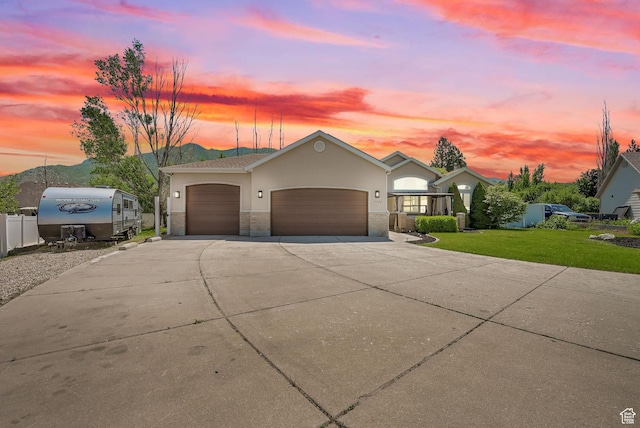 7776 S 2175 E, South Weber, UT 84405 - view of front facade with an attached garage, concrete driveway, stucco siding, and stone siding
