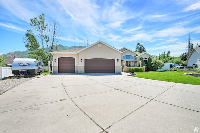 7776 S 2175 E, South Weber, UT 84405 - single story home with a garage, concrete driveway, stucco siding, and stone siding