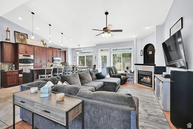 7776 S 2175 E, South Weber, UT 84405 - living room featuring ceiling fan, a tiled fireplace, recessed lighting, vaulted ceiling, and light wood finished floors