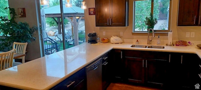 1158 E Ashdown Rd, Cedar City, UT 84721 - kitchen featuring dishwasher, a sink, light countertops, a peninsula, and dark tile patterned flooring
