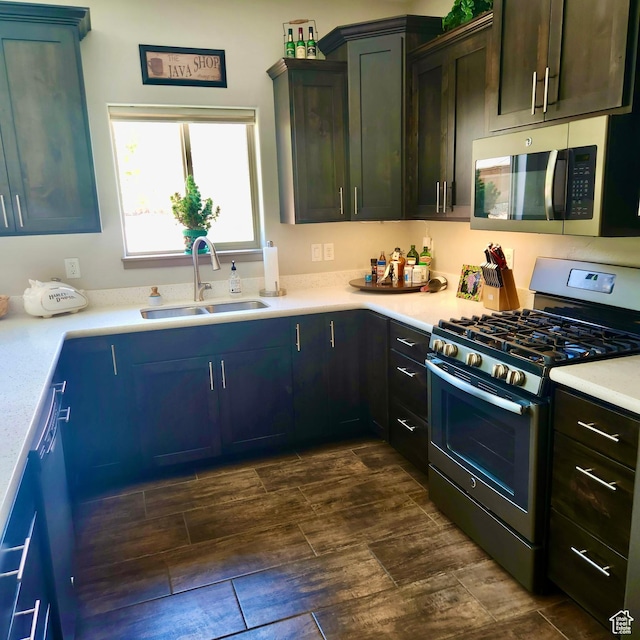 1158 E Ashdown Rd, Cedar City, UT 84721 - kitchen featuring stainless steel appliances, a sink, light countertops, and wood tiled floors