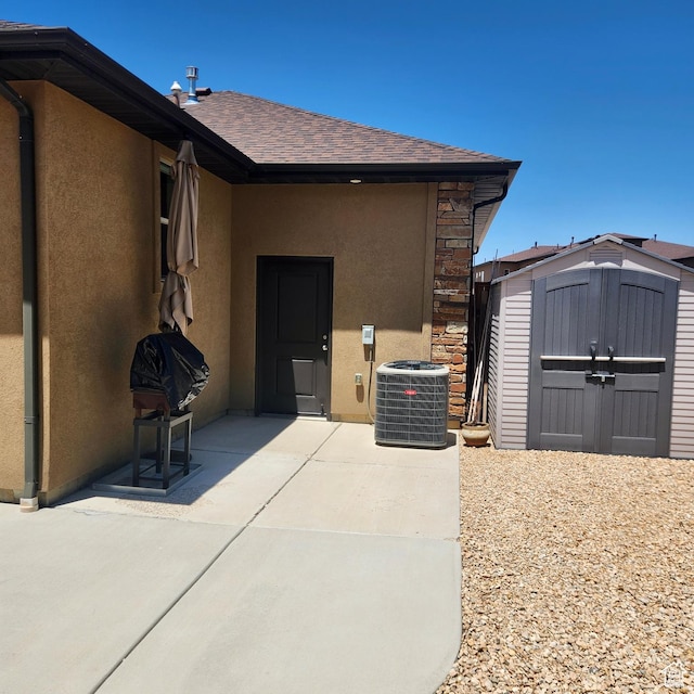 1158 E Ashdown Rd, Cedar City, UT 84721 - entrance to property with stucco siding, a patio, central air condition unit, and a shingled roof