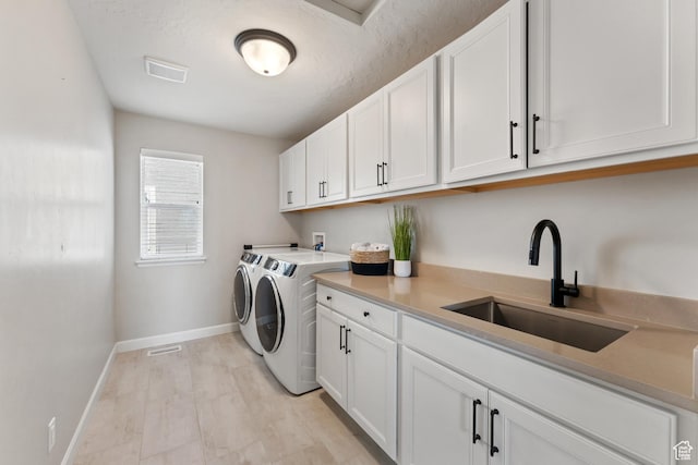 963 W Minuteman Ln, Saratoga Springs, UT 84045 - laundry area featuring washer and dryer, baseboards, and cabinet space