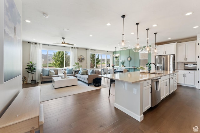 963 W Minuteman Ln, Saratoga Springs, UT 84045 - kitchen with stainless steel appliances, a sink, open floor plan, recessed lighting, and white cabinetry