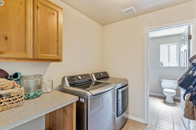 3558 N 3050 W, Farr West, UT 84404 - laundry room featuring washer and dryer, cabinet space, baseboards, and light tile patterned floors