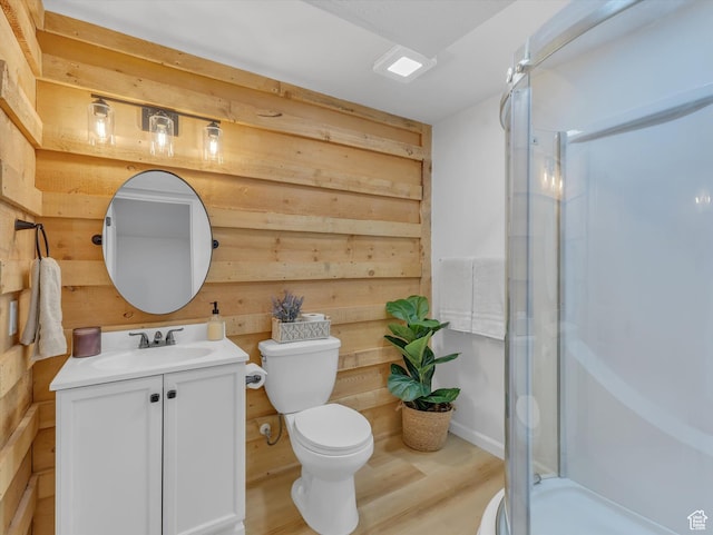 1293 N Buck Run Rd, Rush Valley, UT 84069 - bathroom featuring vanity, toilet, a shower stall, wooden walls, and wood finished floors