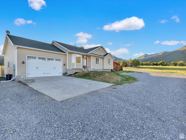 1293 N Buck Run Rd, Rush Valley, UT 84069 - single story home with concrete driveway, an attached garage, and a mountain view