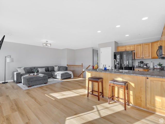 1293 N Buck Run Rd, Rush Valley, UT 84069 - kitchen featuring black appliances, a breakfast bar area, light wood-type flooring, recessed lighting, and a peninsula