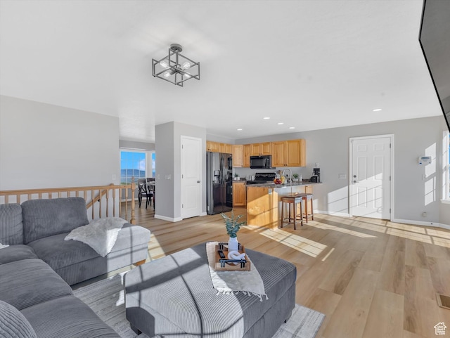 1293 N Buck Run Rd, Rush Valley, UT 84069 - living area featuring baseboards, light wood-type flooring, recessed lighting, and a chandelier