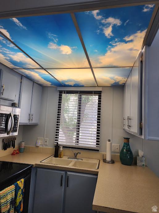 840 N Twin Lakes Dr Unit 127, St George, UT 84770 - kitchen featuring stainless steel microwave, a sink, and light countertops