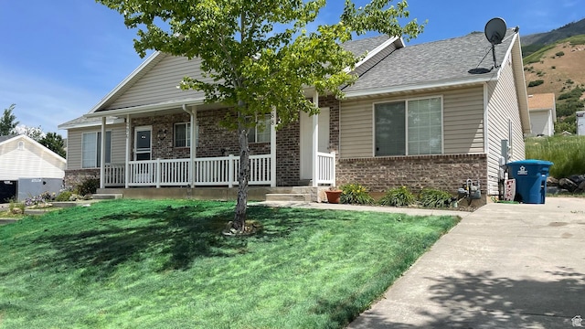 288 N Peach St, Santaquin, UT 84655 - view of front of house with brick siding, a porch, and a front lawn