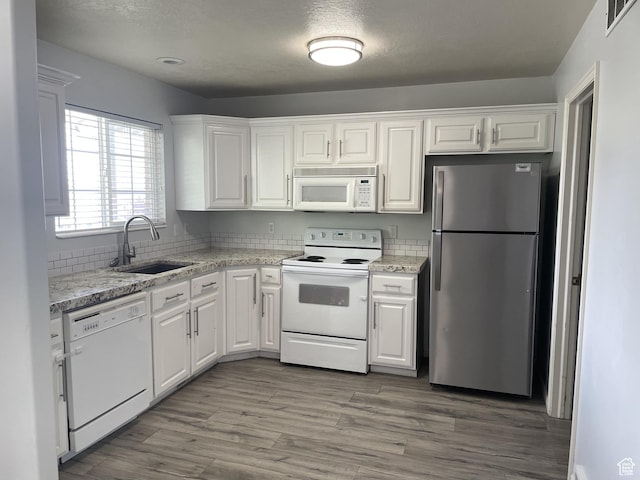 288 N Peach St, Santaquin, UT 84655 - kitchen featuring white appliances, a sink, white cabinets, and backsplash