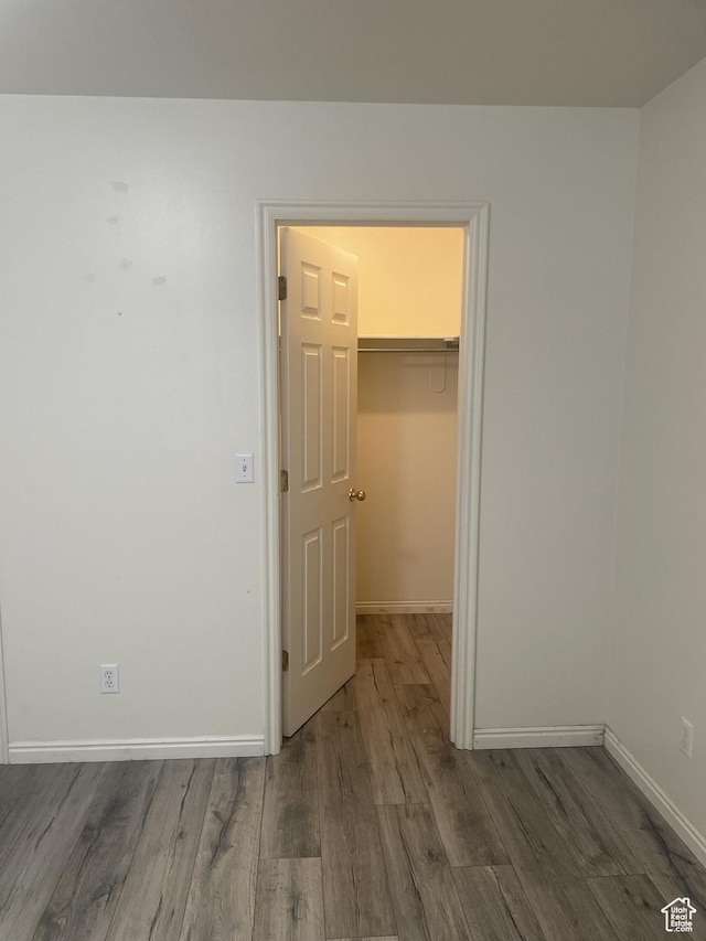 288 N Peach St, Santaquin, UT 84655 - unfurnished bedroom with wood finished floors, a walk in closet, baseboards, and a closet