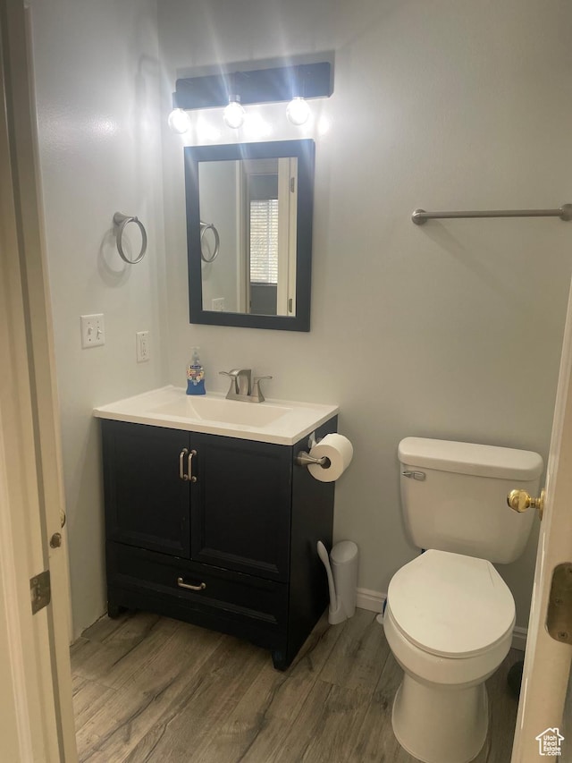 288 N Peach St, Santaquin, UT 84655 - half bath with vanity, wood finished floors, toilet, and baseboards