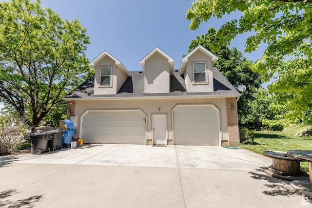 1809 E 1815 N, North Logan, UT 84341 - view of front facade featuring brick siding, driveway, an attached garage, roof with shingles, and stucco siding
