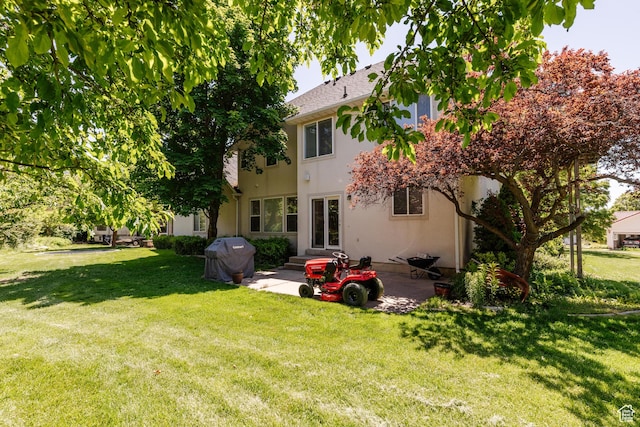 1809 E 1815 N, North Logan, UT 84341 - back of property with a patio area, a yard, and stucco siding