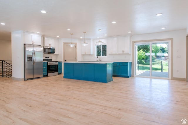286 E 870 N, Logan, UT 84321 - kitchen with stainless steel appliances, light wood finished floors, white cabinetry, recessed lighting, and light countertops
