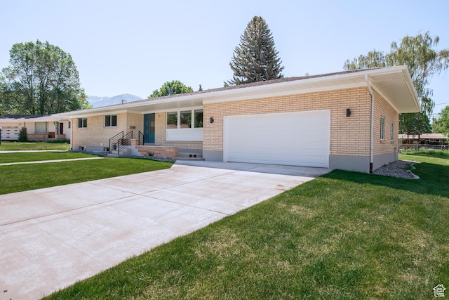 286 E 870 N, Logan, UT 84321 - single story home featuring brick siding, a garage, driveway, and a front lawn