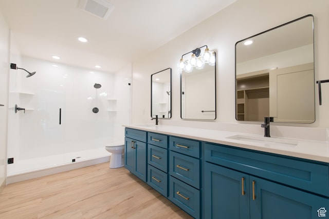 286 E 870 N, Logan, UT 84321 - full bathroom with a shower stall, wood finished floors, double vanity, toilet, and recessed lighting