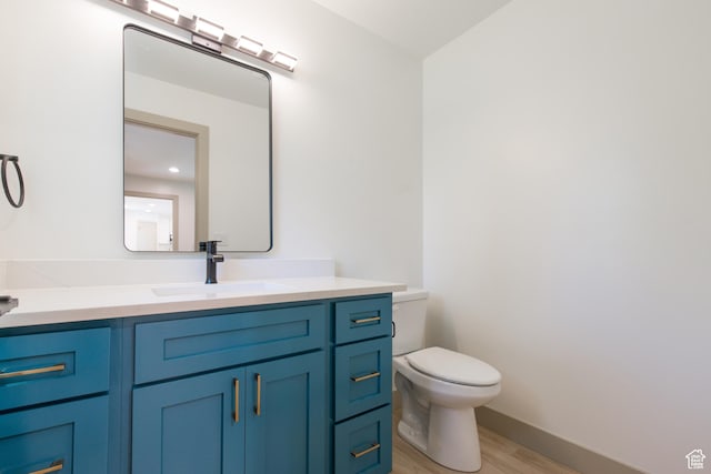 286 E 870 N, Logan, UT 84321 - half bath featuring wood finished floors, toilet, vanity, and baseboards