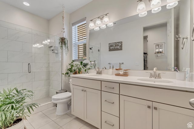 2103 N Elderberry Dr W Unit 222, Saratoga Springs, UT 84045 - bathroom featuring a shower stall, double vanity, tile patterned floors, and toilet