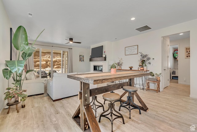 2103 N Elderberry Dr W Unit 222, Saratoga Springs, UT 84045 - dining space featuring a glass covered fireplace, a ceiling fan, light wood-type flooring, and recessed lighting