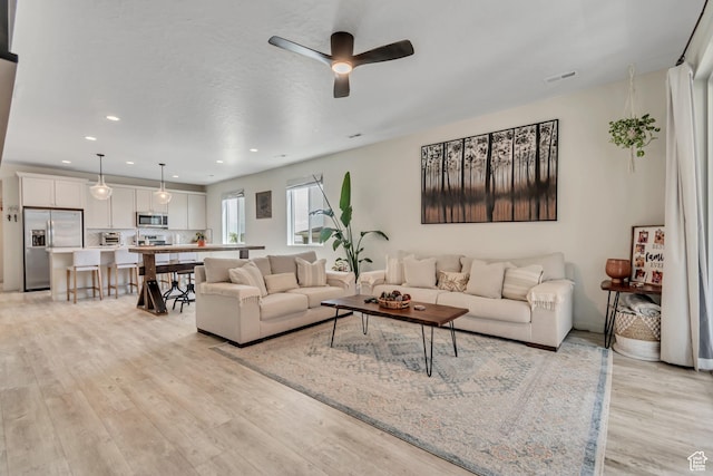 2103 N Elderberry Dr W Unit 222, Saratoga Springs, UT 84045 - living room featuring light wood-type flooring, a ceiling fan, and recessed lighting