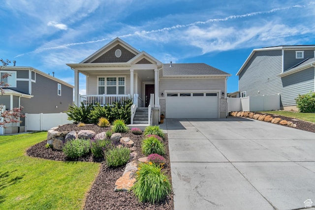 2103 N Elderberry Dr W Unit 222, Saratoga Springs, UT 84045 - view of front of property featuring a garage, covered porch, and concrete driveway