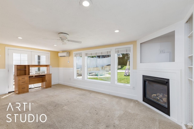162 E 3000 S, Bountiful, UT 84010 - unfurnished living room with a wall mounted AC, carpet, a ceiling fan, wainscoting, and a glass covered fireplace