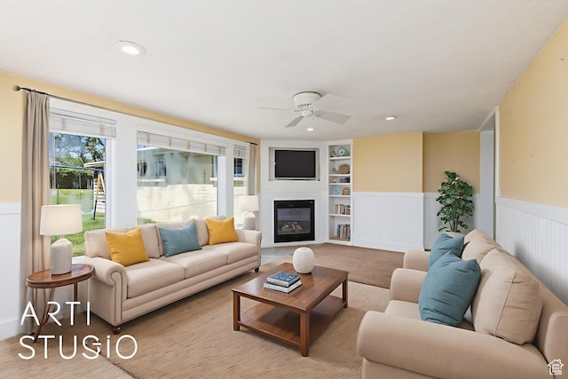 162 E 3000 S, Bountiful, UT 84010 - living area with built in shelves, a ceiling fan, wainscoting, a glass covered fireplace, and recessed lighting
