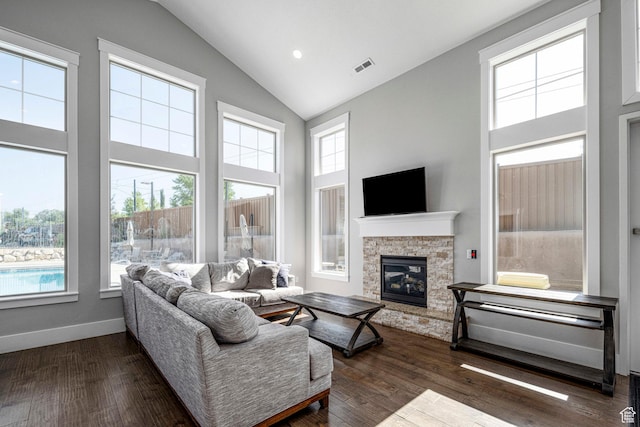 261 E Sage Canal Way, Sandy, UT 84070 - living area featuring high vaulted ceiling, healthy amount of natural light, a stone fireplace, and dark wood-type flooring