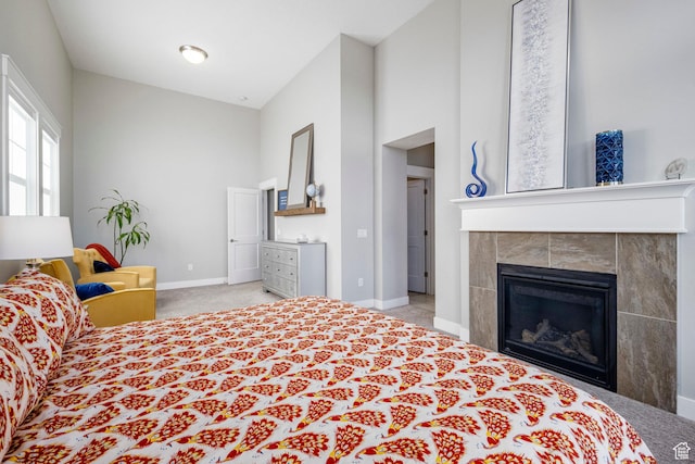 261 E Sage Canal Way, Sandy, UT 84070 - carpeted bedroom with baseboards, a tiled fireplace, and a towering ceiling