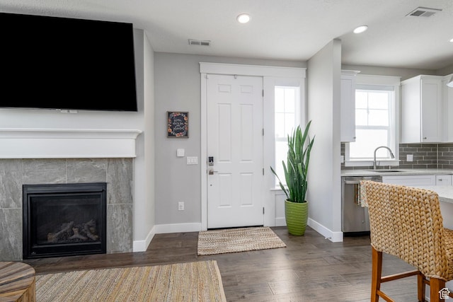 261 E Sage Canal Way, Sandy, UT 84070 - foyer entrance with dark wood-style flooring, baseboards, recessed lighting, and a tile fireplace