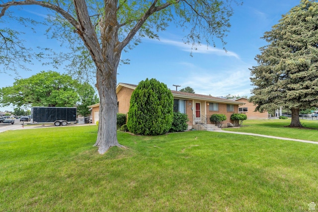 1031 N 1750 W, Provo, UT 84604 - view of front of house with a front yard, brick siding, and an attached garage