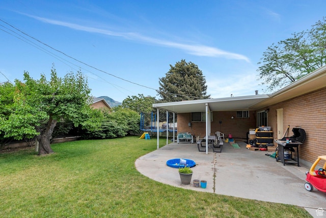1031 N 1750 W, Provo, UT 84604 - view of grassy yard featuring a trampoline and a patio