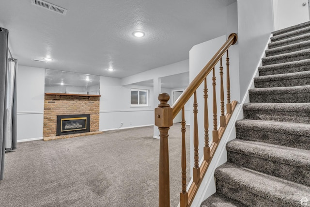 648 E 6870 S, Midvale, UT 84047 - stairway with carpet floors, baseboards, a brick fireplace, a textured ceiling, and recessed lighting