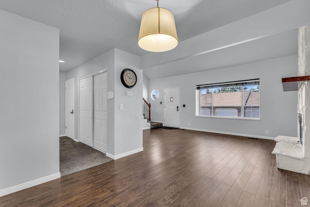 648 E 6870 S, Midvale, UT 84047 - unfurnished living room with stairs, dark wood-type flooring, and baseboards