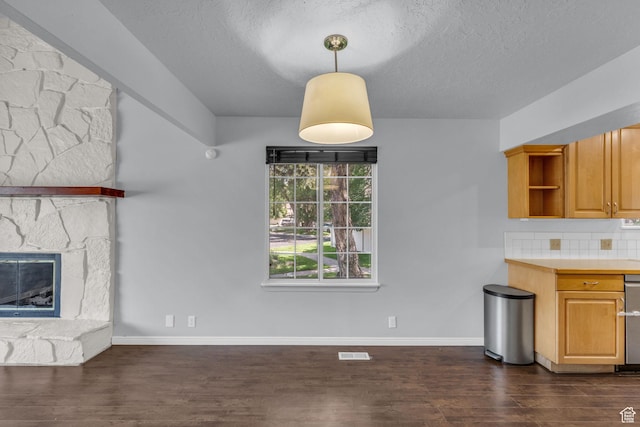 648 E 6870 S, Midvale, UT 84047 - unfurnished living room with dark wood-type flooring, a textured ceiling, baseboards, and a fireplace