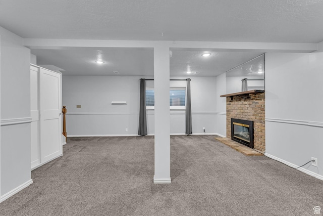 648 E 6870 S, Midvale, UT 84047 - unfurnished living room with carpet flooring, a fireplace, baseboards, recessed lighting, and a textured ceiling
