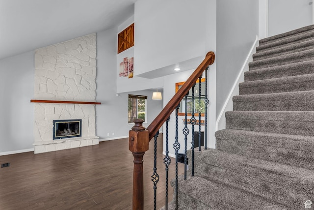 648 E 6870 S, Midvale, UT 84047 - stairway featuring high vaulted ceiling, wood finished floors, baseboards, and a stone fireplace
