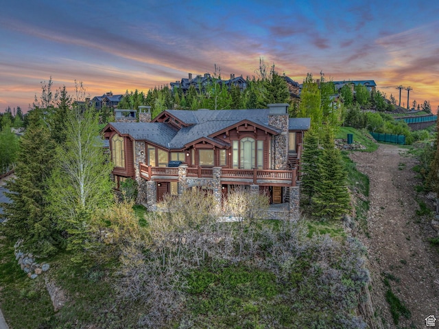 9968 Summit View Dr, Heber City, UT 84032 - rear view of property featuring a chimney, stone siding, and a balcony