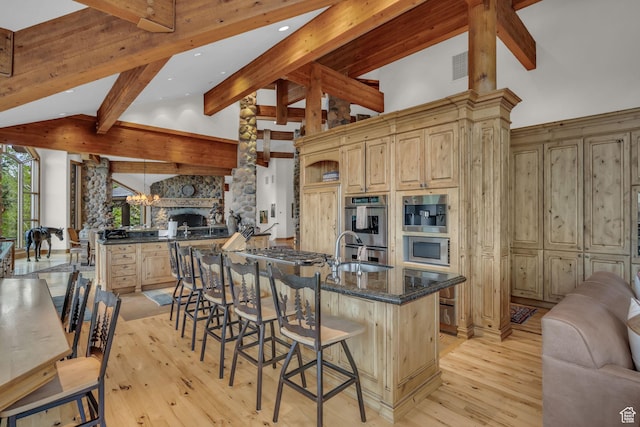 9968 Summit View Dr, Heber City, UT 84032 - kitchen with open floor plan, a sink, beam ceiling, light wood-style flooring, and light brown cabinets