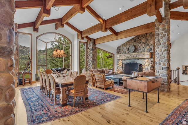 9968 Summit View Dr, Heber City, UT 84032 - dining space with beam ceiling, hardwood / wood-style floors, a fireplace, a chandelier, and high vaulted ceiling