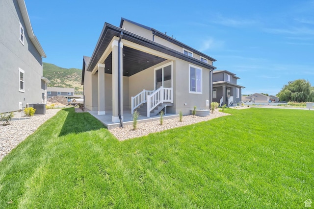 2131 N 725 W, Centerville, UT 84014 - back of property with central air condition unit, stucco siding, a yard, and a mountain view